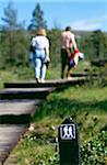 Couple walking on wooden path