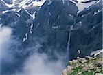 Walker looking over waterfall at Cirque de Gavarnie