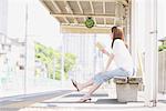 Japanese Teenage Girl Waiting On Platform