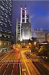 Traffic passing along Queen's Road Central with HSBC building in background, Central, Hong Kong, China