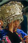 China, Guizhou Province, nr. Kaili, Langde. A Miao (or Hmong) girl wears a traditional silver-alloy headdress