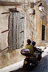 Street view in Arles, France. Motorcycling through the side streets.