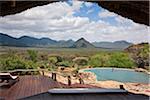 Kenya, A guest enjoying the natural rock swimming pool of Sarara Camp, an ecolodge situated near the Mathews Mountains