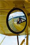 Kenya, Laikipia, Lewa Downs. Will Craig flies his 1930s style Waco Classic open cockpit bi-plane as the ultimate aerial safari.