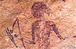 Libya, Fezzan, Jebel Akakus. A painted figure lies hidden on the walls of Graibu, one of Wadi Teshuinat's  caves