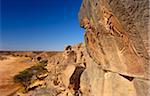 Libya, Fezzan, Messak Settafet. A petroglyph of felines, known as the 'dancing cats' -stands by a ledge high above Wadi Mathendusch.