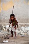 Mozambique, Ihla de Moçambique, Stone Town. An industrious young girl poses with her broom.