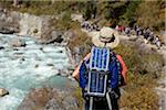 Nepal, Everest Region, Khumbu Valley. Trekking on the Everest Base Camp Trail using a solar panel to charge electical equipment