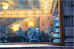 Russia, St. Petersburg; A girl on her mobile phone behind a shop window