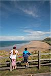 Wales; Gower Peninsula. A young boy and girl look out across Rhossili Bay.