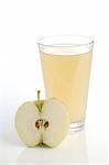 Halved apple and glass of apple juice