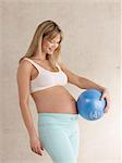 Pregnant woman holding ball
