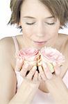 Woman smelling at rose blooms