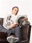 Man on couch holding coffee-table book