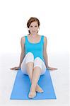 Woman sitting on yoga mat