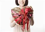 Woman holding heart-shaped gift
