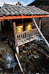 China, Sichuan Province, Jiuzhaigou National Park, Unesco Site, prayer wheels being turned by the flow of river water