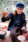 China, Guizhou Province, Qingman Miao village, a man eating at a festival