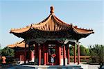 China, Beijing, Ethnic Minorities Park, a girl with parasol at a pavilion