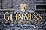 Ireland, Dublin, St James Gate, The Guinness logo and trademark on the wall of the St. James' Gate Brewery.