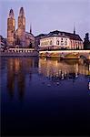 Switzerland, Zurich, Romanesque style Grossmunster protestant reformation church with the Limmat river in the foreground.