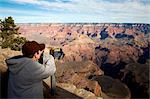 United States; Arizona; Grand Canyon. A boy uses a telescope to view the Grand Canyon from the South rim