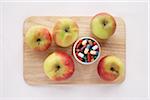 Apples and Pills on Cutting Board