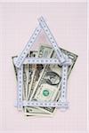 House Made of Expandable Ruler and American Currency on Graph Paper