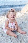 Baby Girl Sitting on Beach