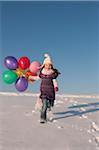 Girl with Balloons Running Down Hill in Winter