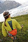 Woman hiking alongside  Exit Glacier in the Harding Icefield, Kenai Fjords National Park, Kenai Peninsula, Southcentral Alaska, Summer