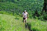 Female jogger runs the Near Point Trail in Chugach State Park near Anchorage, Southcentral Alaska, Summer