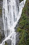 Ribbon-like waterfall cascades into Endicott Arm Fjord in Tracy Arm-Fords Terror Wilderness, Tongass National Forest,  Inside Passage of Southeast Alaska, Summer