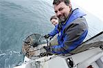 Couple celebrates catching a bunch of six-inch shrimp in Prince William Sound off Pt. Pigot, about 10 miles west of Whittier, Southcentral Alaska, Spring