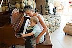 Grandmother and grandson playing the piano