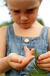 A girl with a ladybird on her hand.