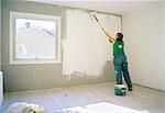 A woman painting a wall, Sweden.