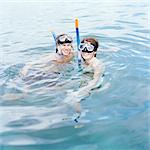 Young couple with schnorkel and diving-masks, Thailand.