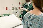 Patient watching as nurse prepares medical equipment