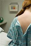 Female patient with examination gown open in back