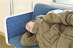 Adult man sleeping in a train