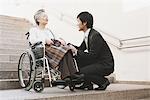 Young-Adult Man Talking With Elderly Woman