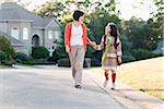 Mother and Daughter Walking and Holding Hands