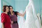 Mother and daughter looking at wedding dresses