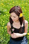 Young woman in field with dandelions