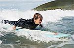 Young boy surfing on a wave