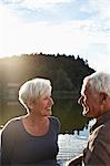 Senior couple sitting at jetty