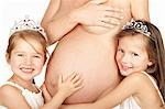 Pregnant woman with her two daughters