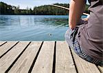 Man on jetty, fishing with bamboo rod