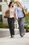 Business women having fun on sidewalk